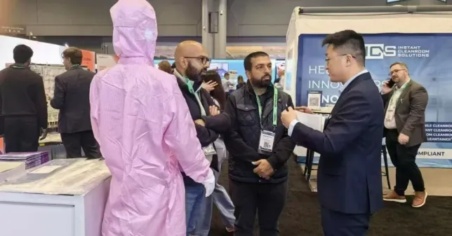WIPESTAR cleanroom consumables team discussing wiping cloth solutions with international visitors at a 2026 trade show exhibition booth