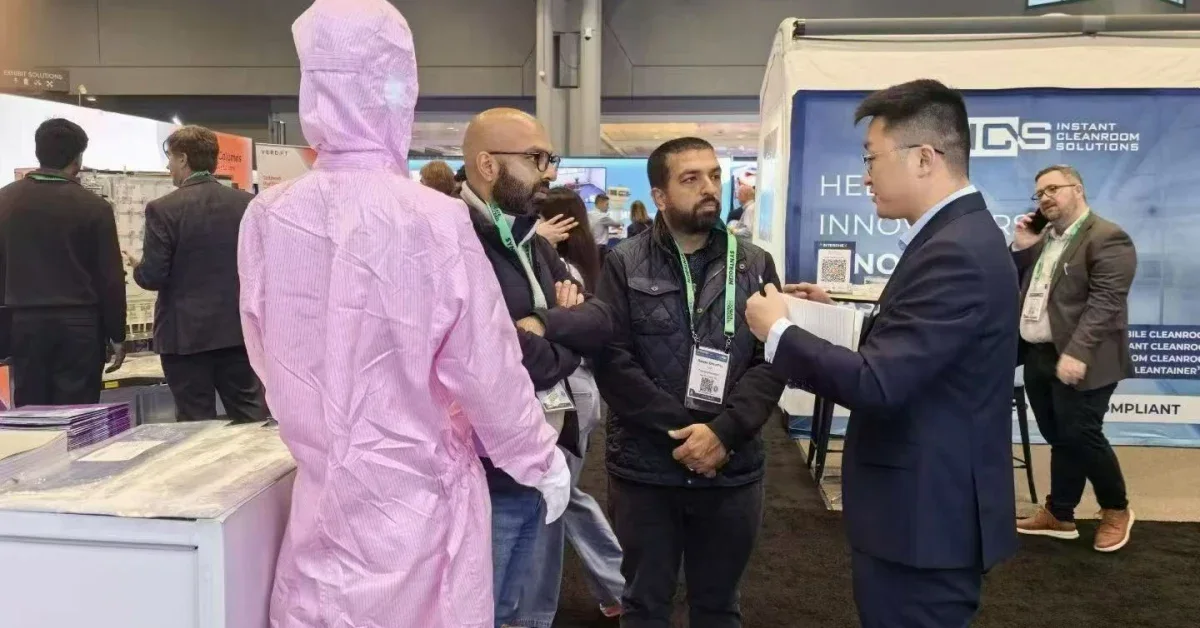 WIPESTAR cleanroom consumables team discussing wiping cloth solutions with international visitors at a 2026 trade show exhibition booth